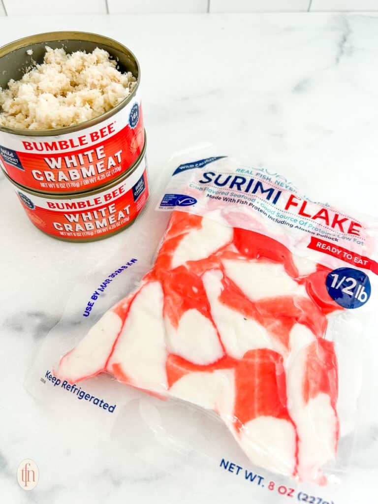 Two cans of white crabmeat and a bag of surimi flake for cajun crab dip with shrimp.