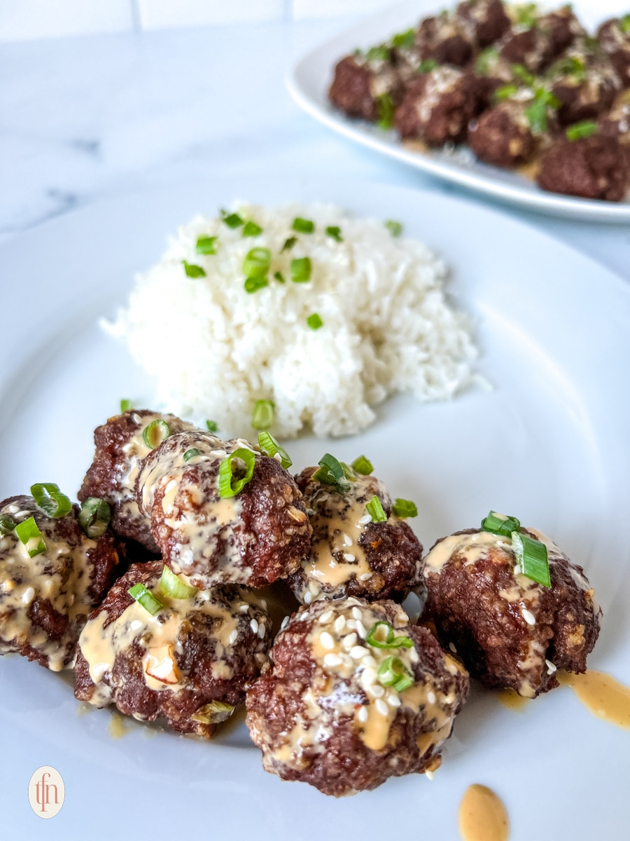 A plate of firecracker meatballs and rice.