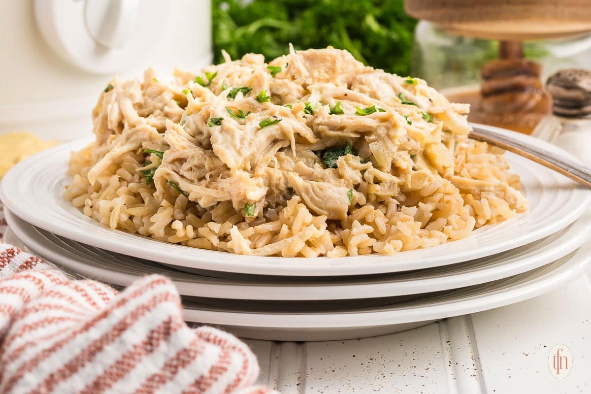 Shredded chicken over brown rice ready to serve.