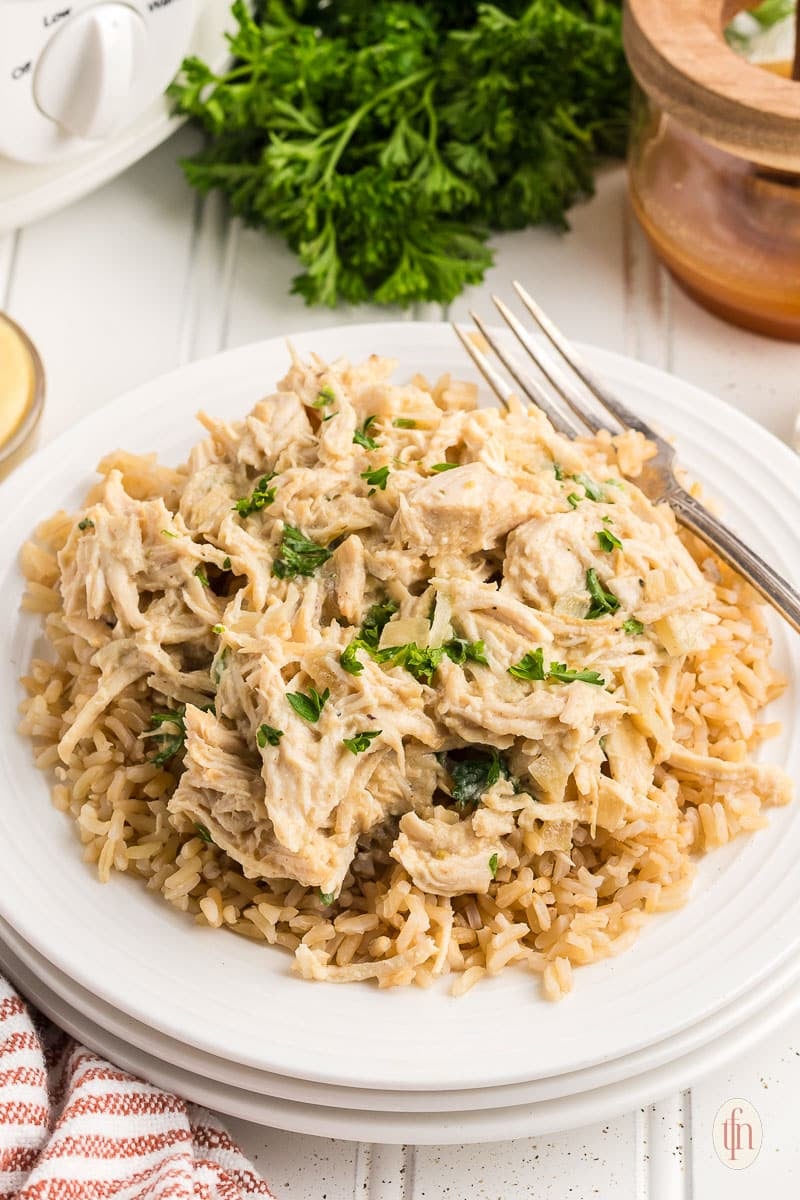 a bowl of honey mustard chicken over rice ready to serve.