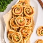 Ham and cheese pinwheels on a serving platter.