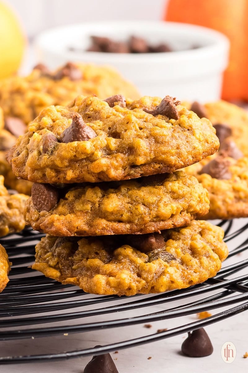 three cookies stacked on a cooling rack.