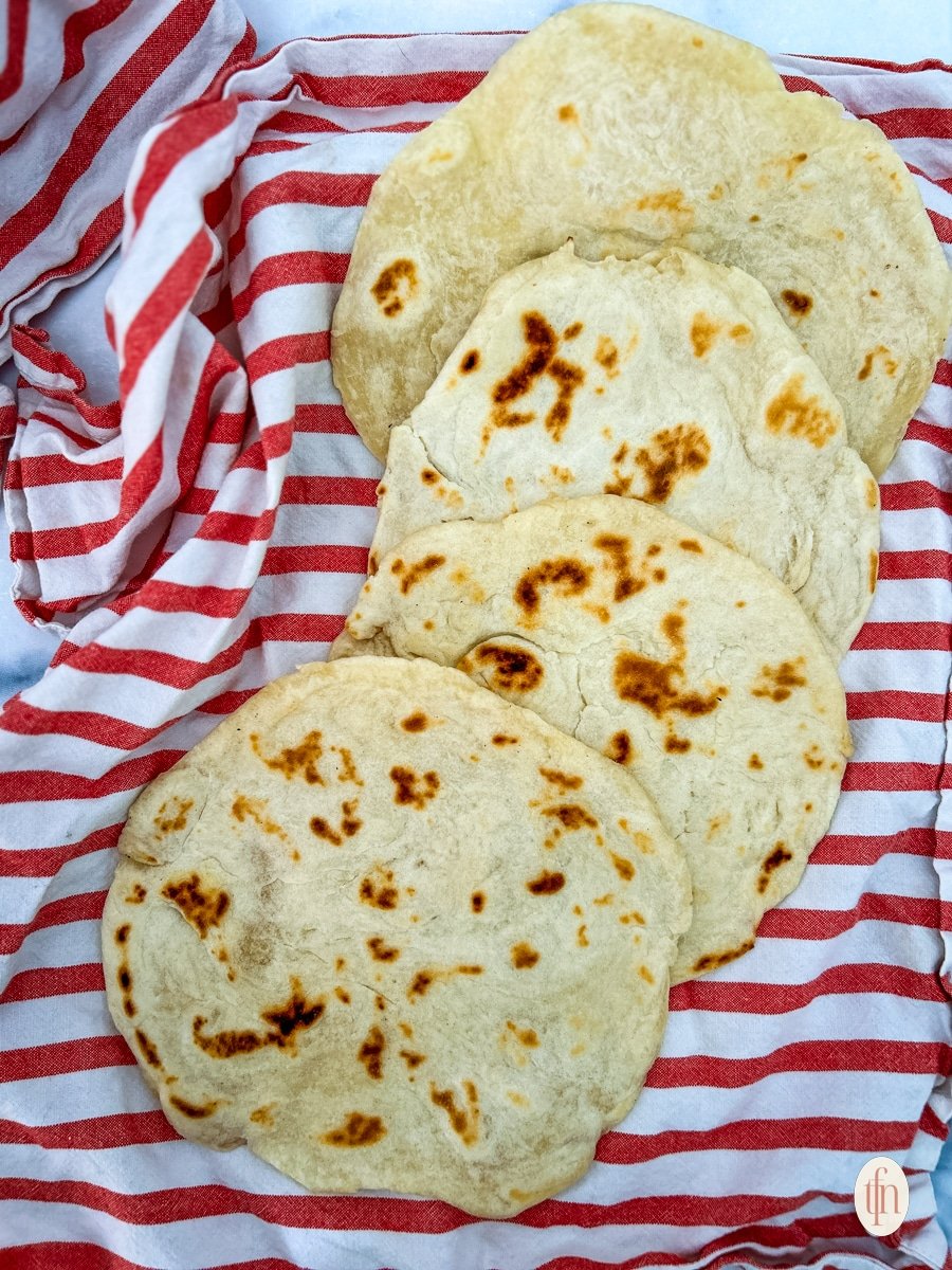 Sourdough flatbread on a red kitchen towel.