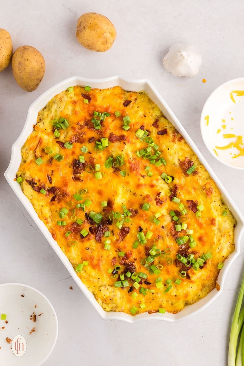 A casserole dish of baked mashed potatoes recipe.