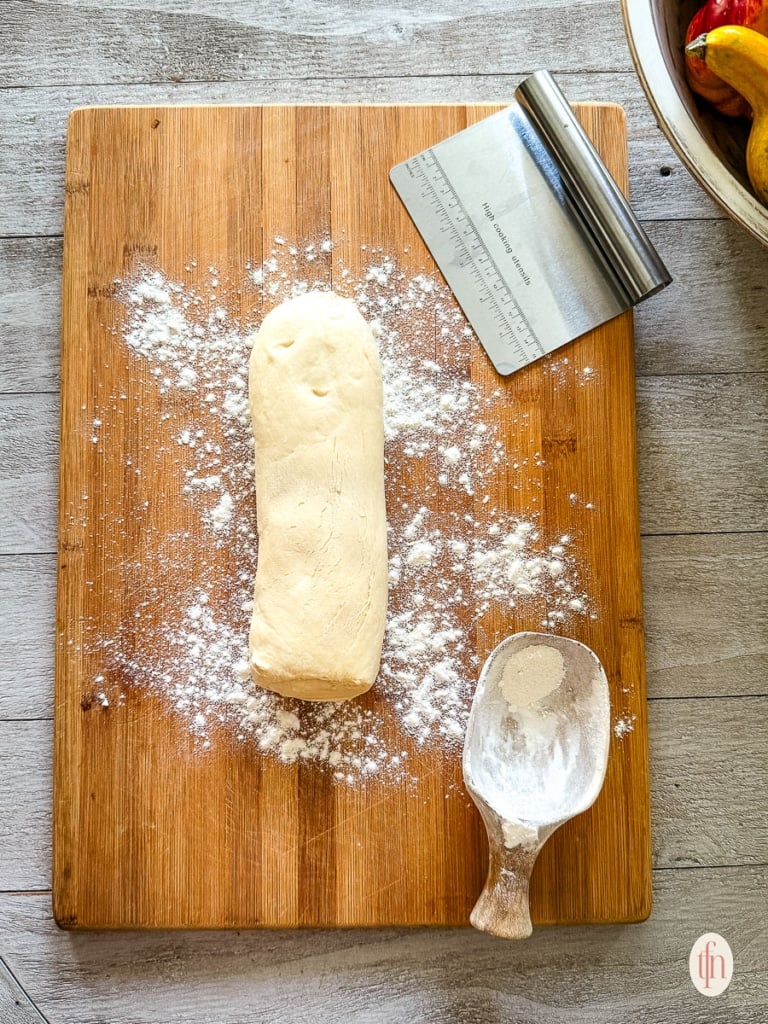 Thawed roll of frozen bread dough ready to cut into pieces.