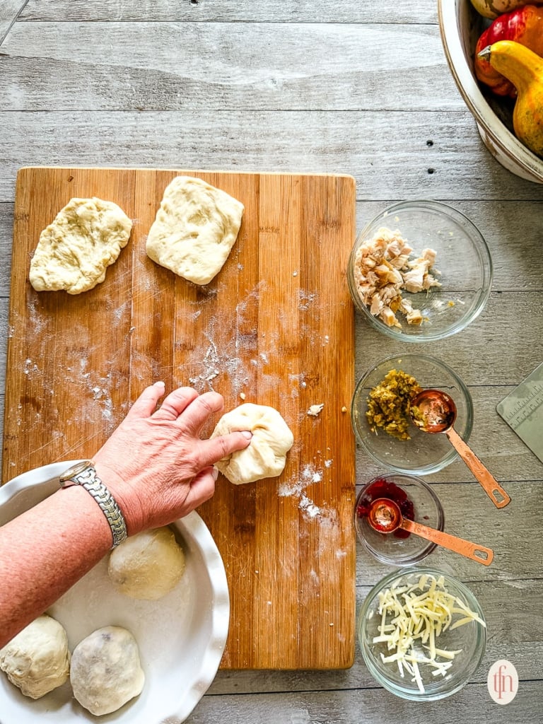 Sealing the stuffed roll before baking.