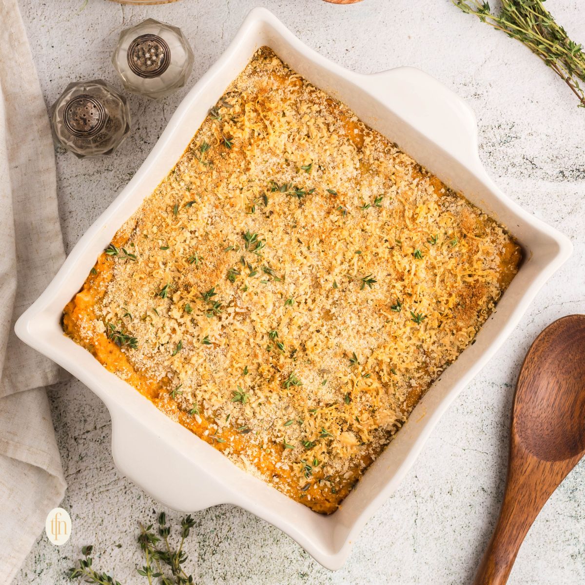 Sweet potato casserole with canned yams in a white baking dish.