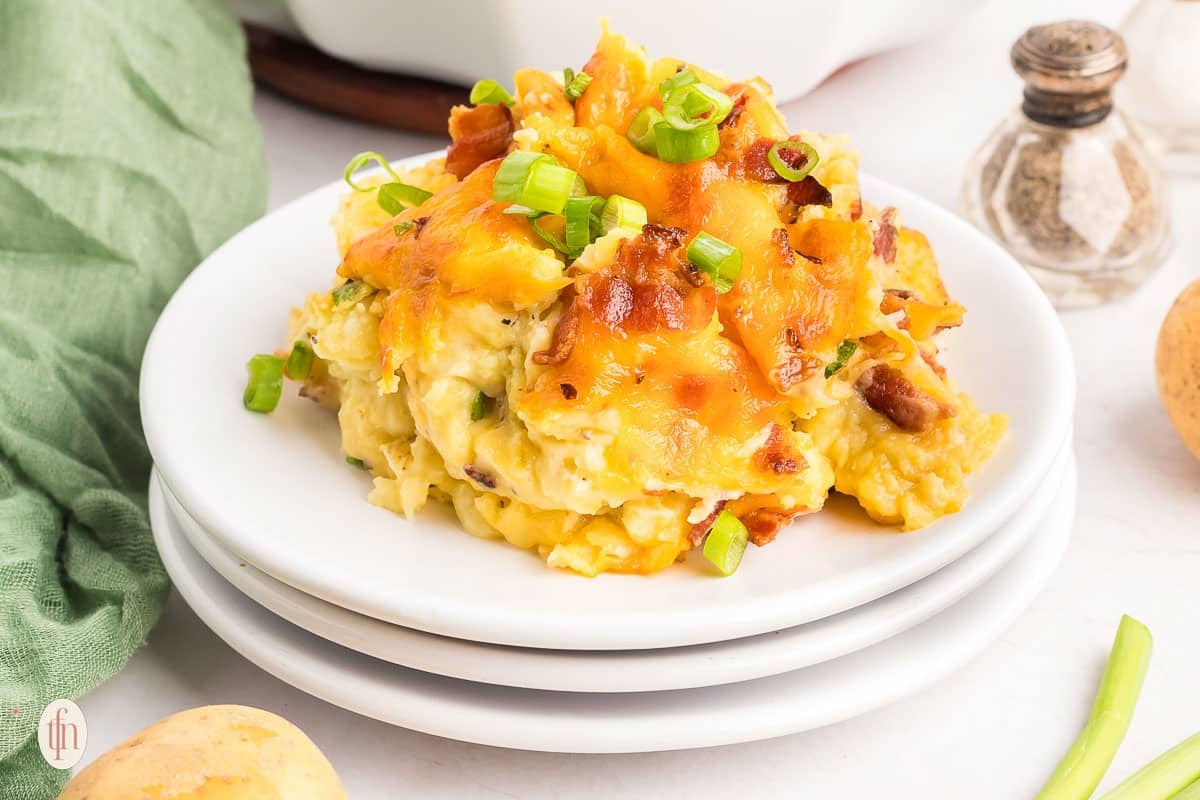 Twice baked mashed potatoes on a white plate.