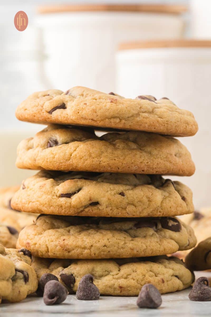 Chocolate chip cookies stacked.