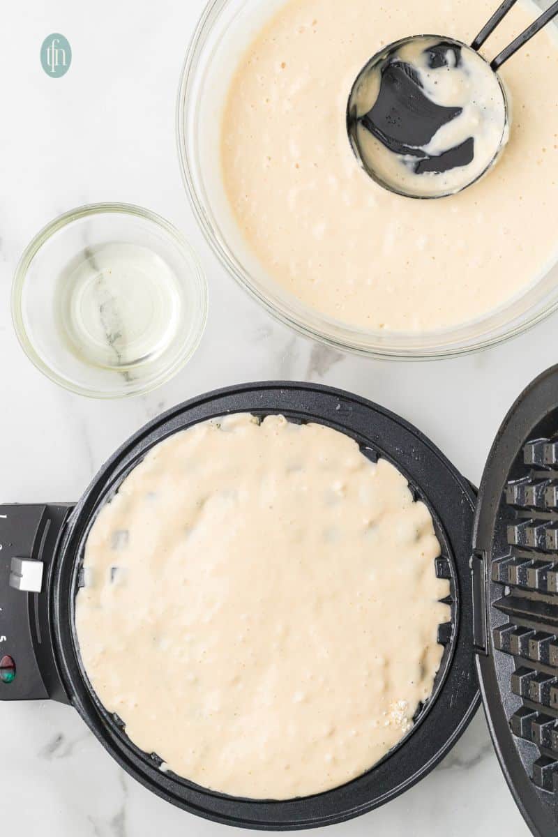 A batter mixture on a waffle maker.