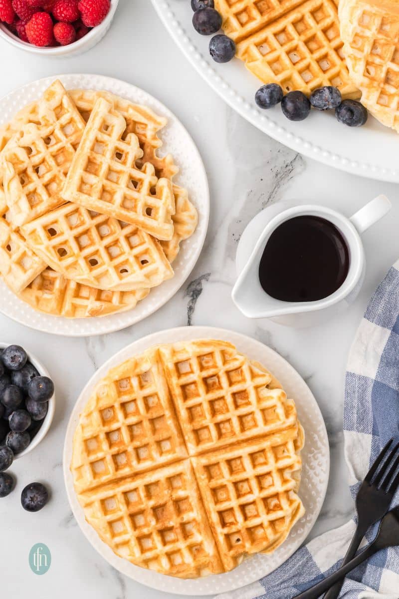 Two plates of waffles.