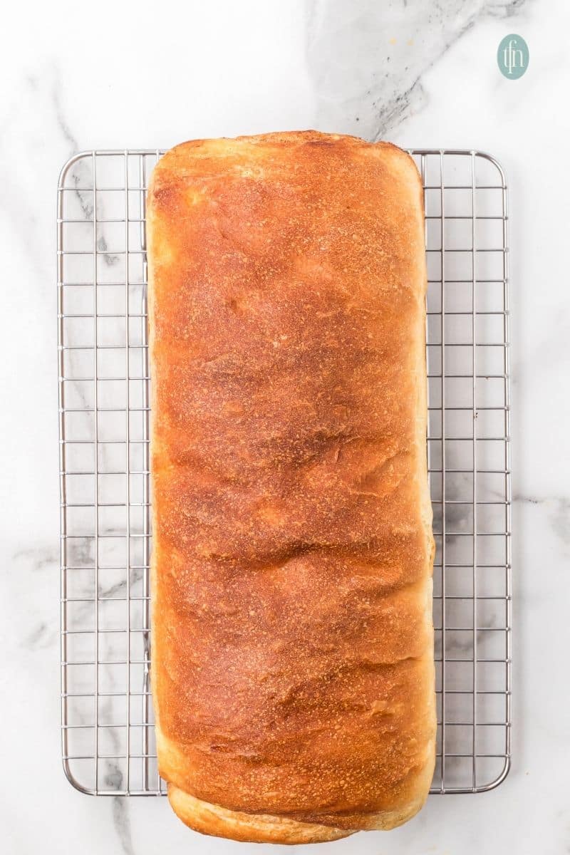 Baked loaf on a cooling rack.