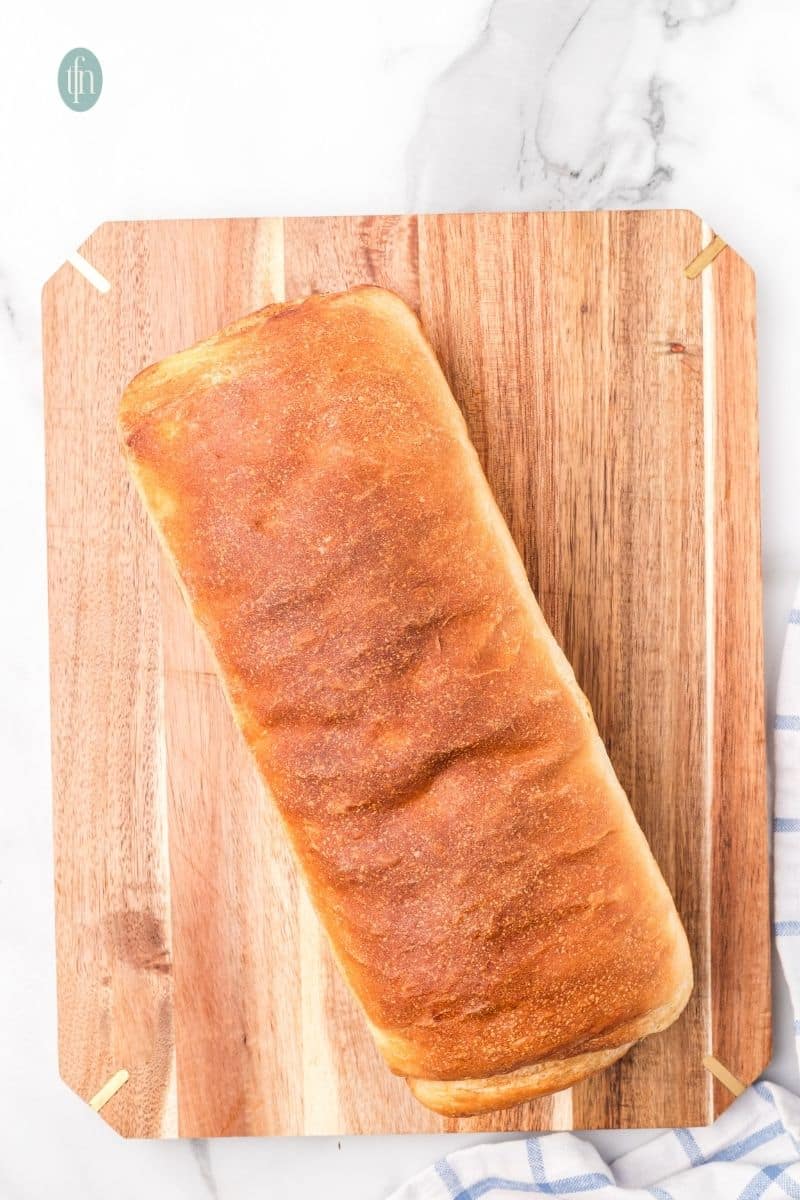 Baked loaf on a wooden board.