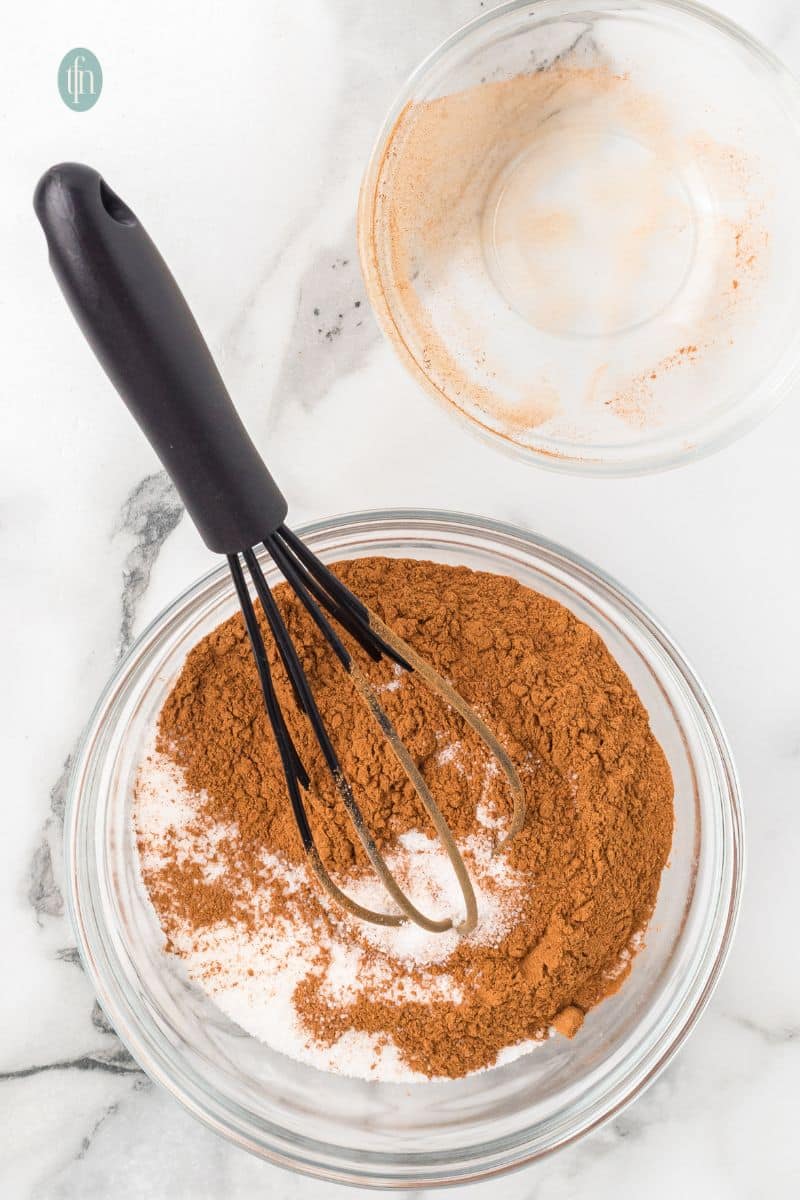 A bowl of dry mixture with whisk.