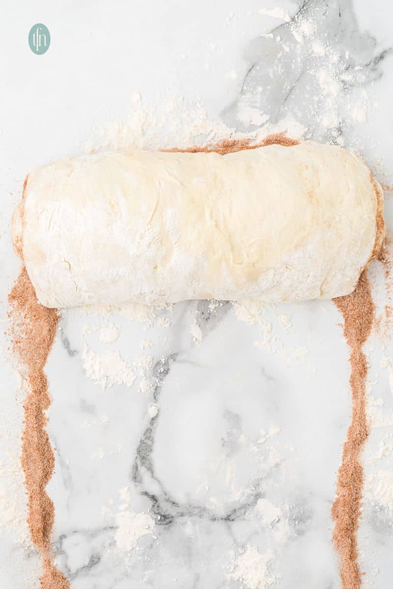 Rolled dough on a counter top.