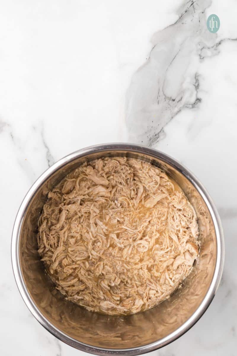 A bowl of shredded chicken.