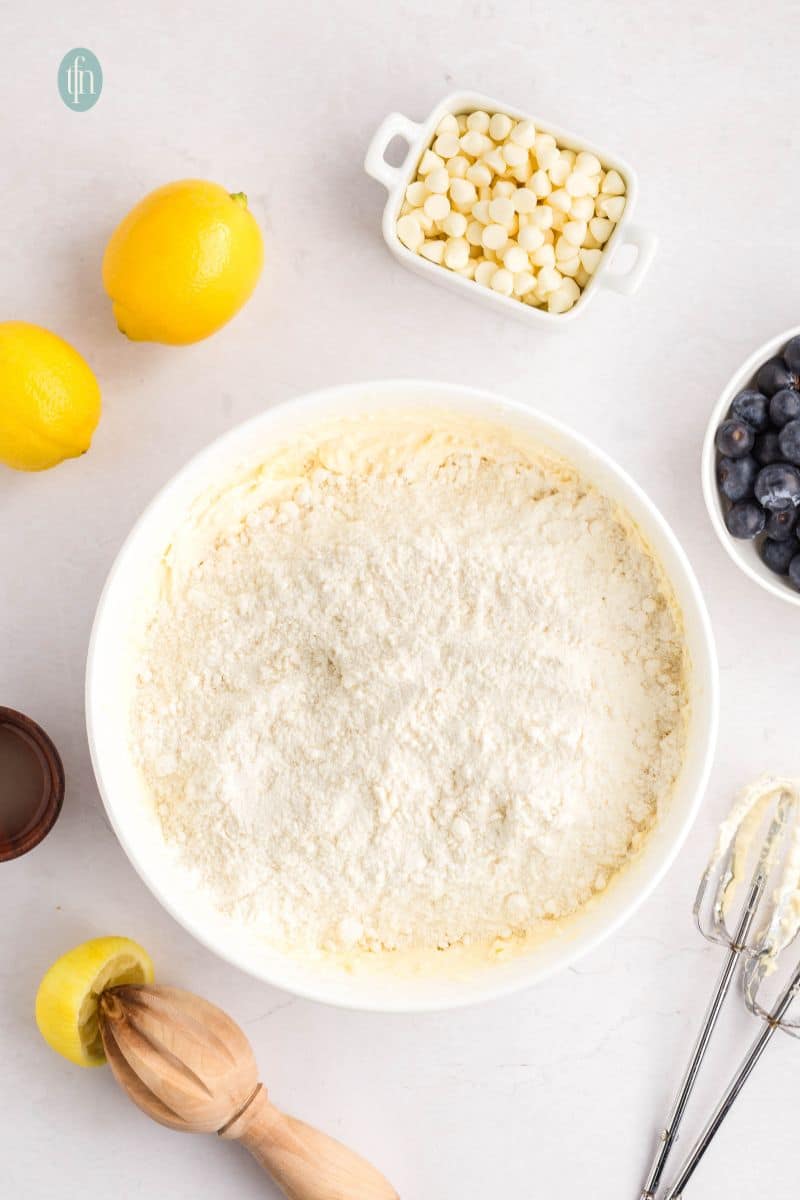 A creamed batter in a white bowl with powdered ingredients.