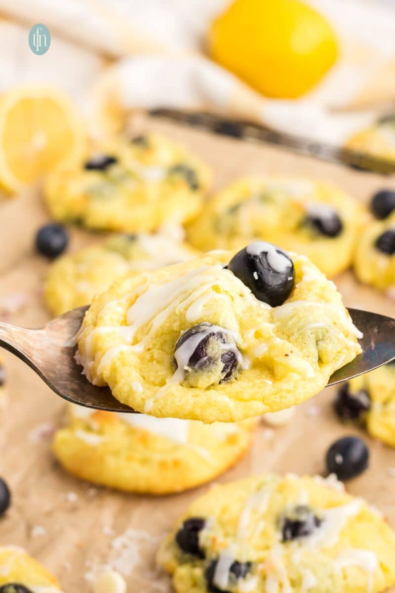 A cookie with blueberries and glaze.