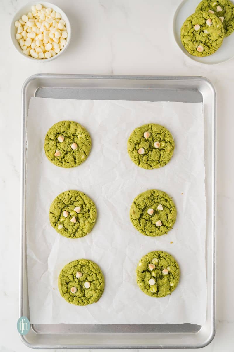 Baked cookies on a baking pan with parchment paper.