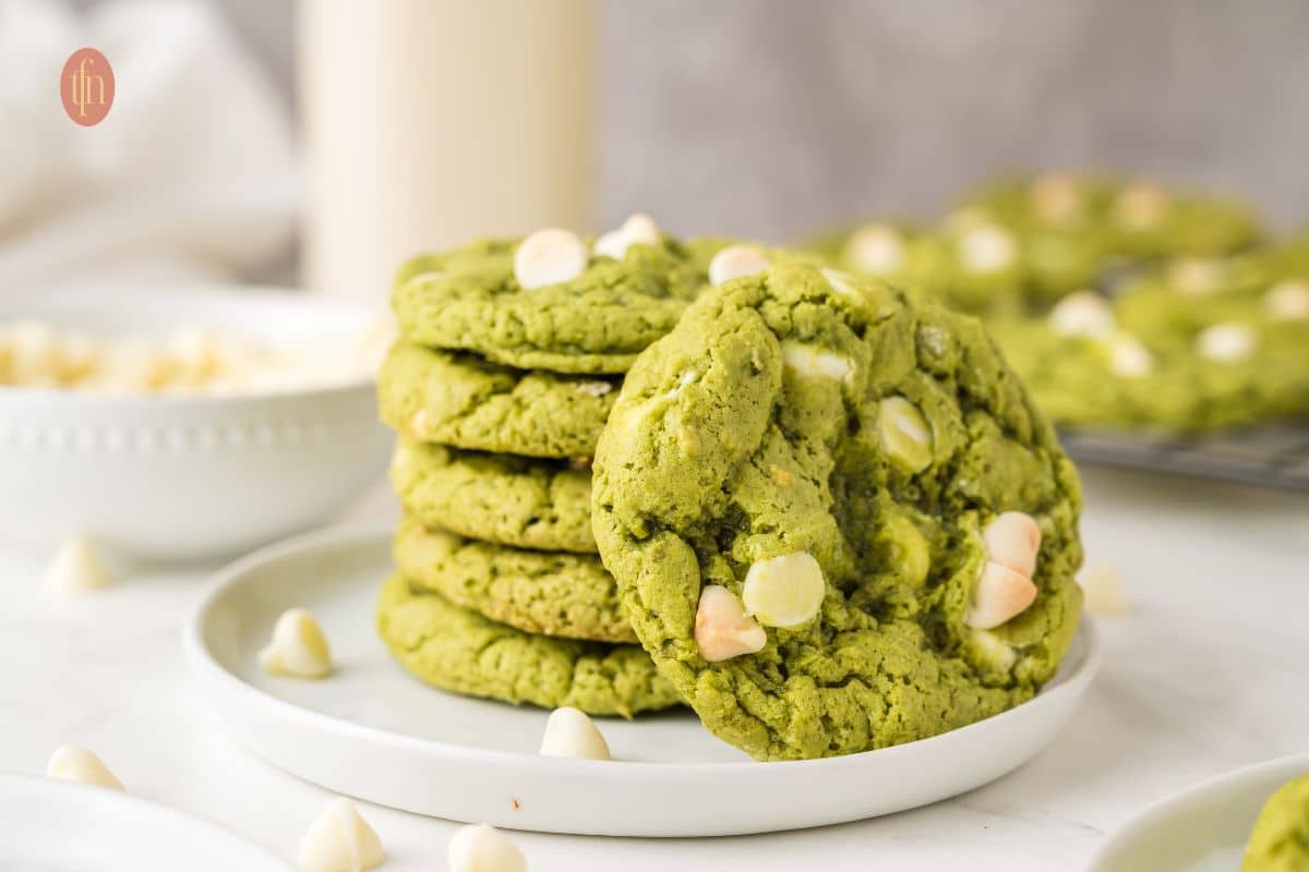 A plate of stacked green cookies.