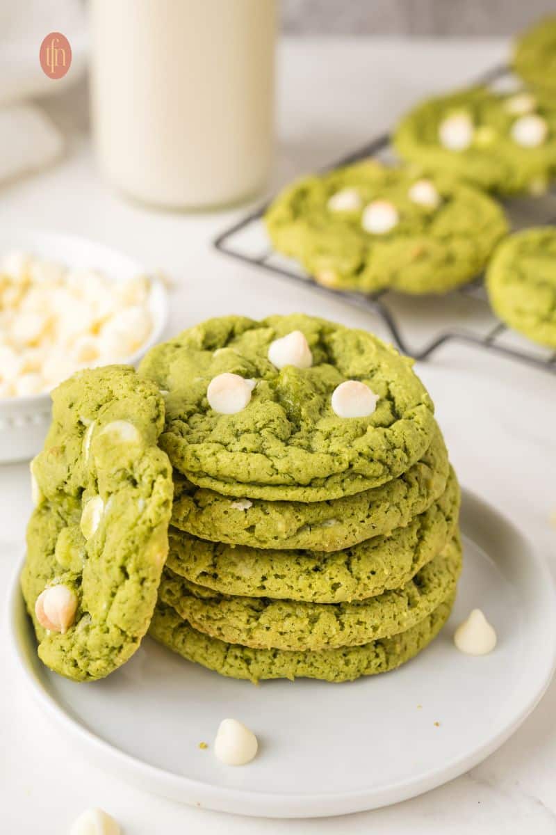A plate of stacked green cookies.