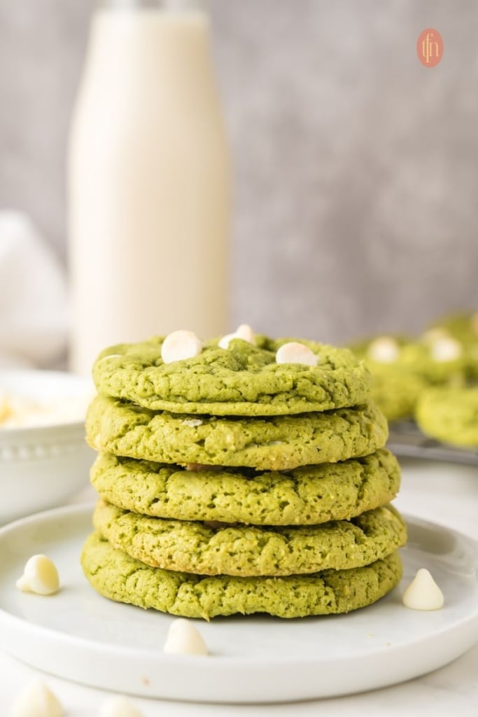 A plate of stacked green cookies.