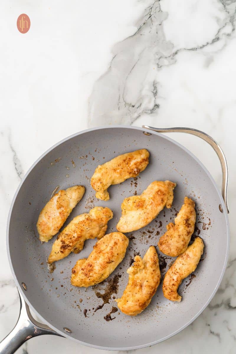 Cooked chicken on a frying pan.