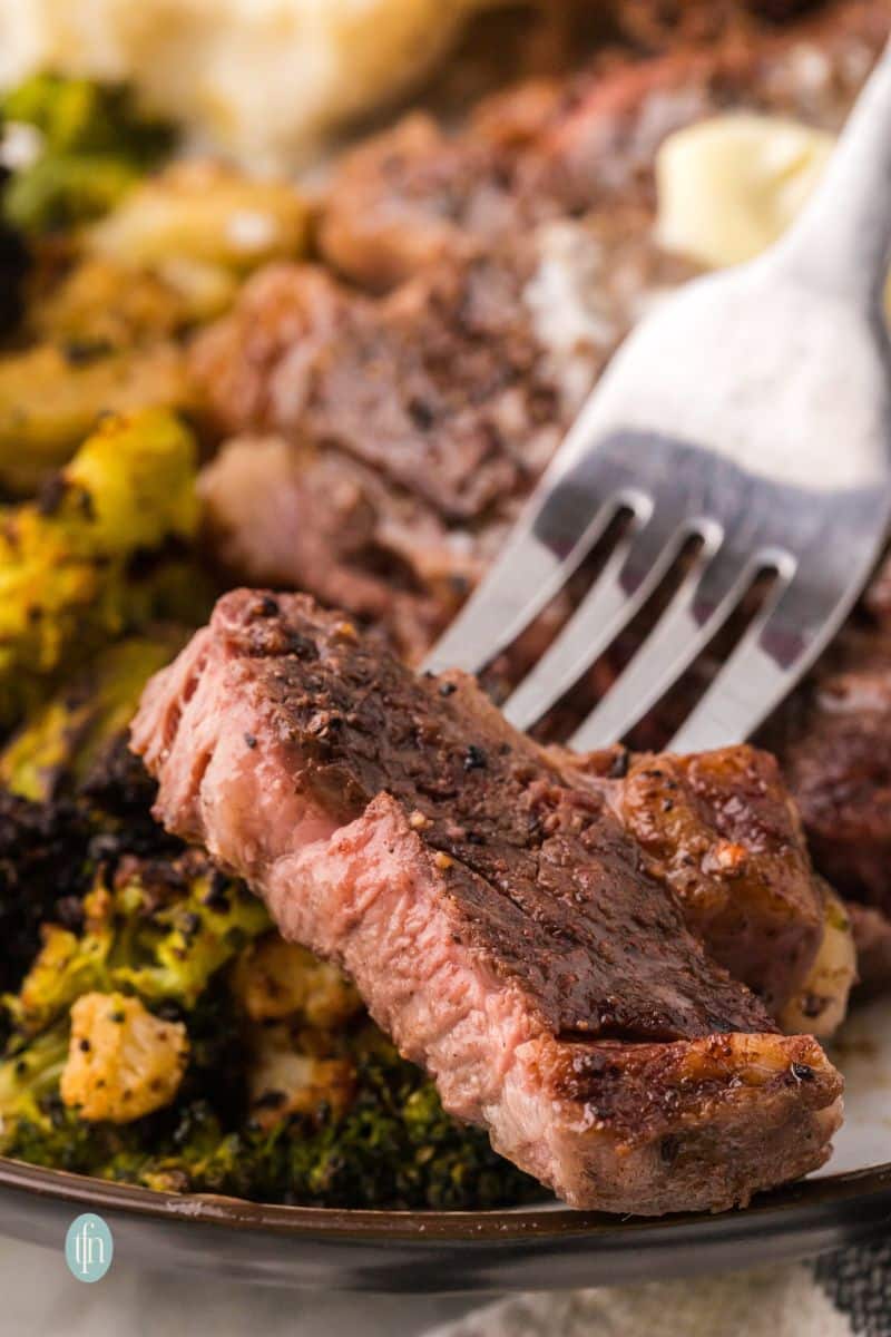 A plate of steak with broccoli.
