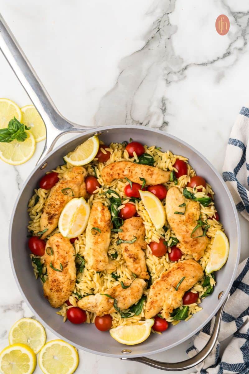 A pan of chicken and orzo.