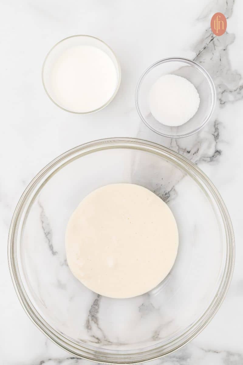A bowl of sourdough starter, milk, and sugar.