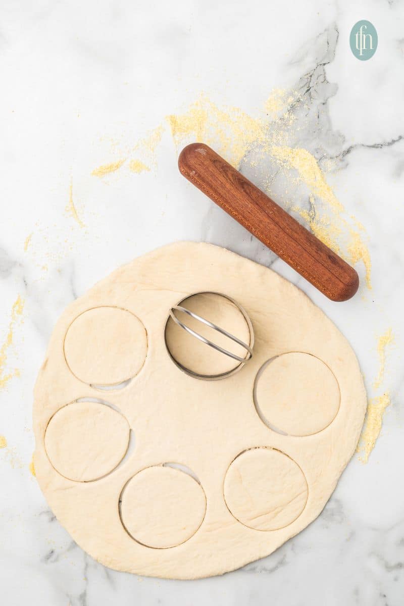 Rolled dough with a cookie cutter and rolling pin.