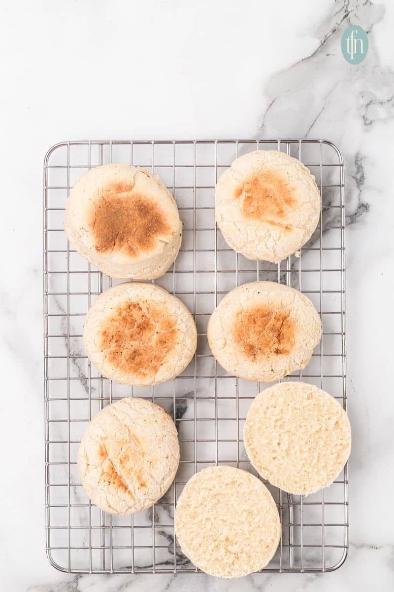 English muffins on a cooling rack.