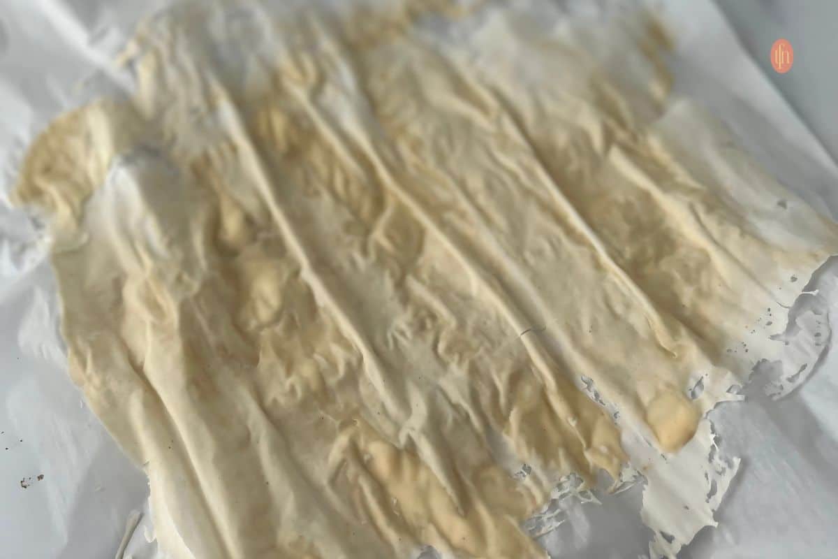 Dried sourdough starter on a parchment paper.
