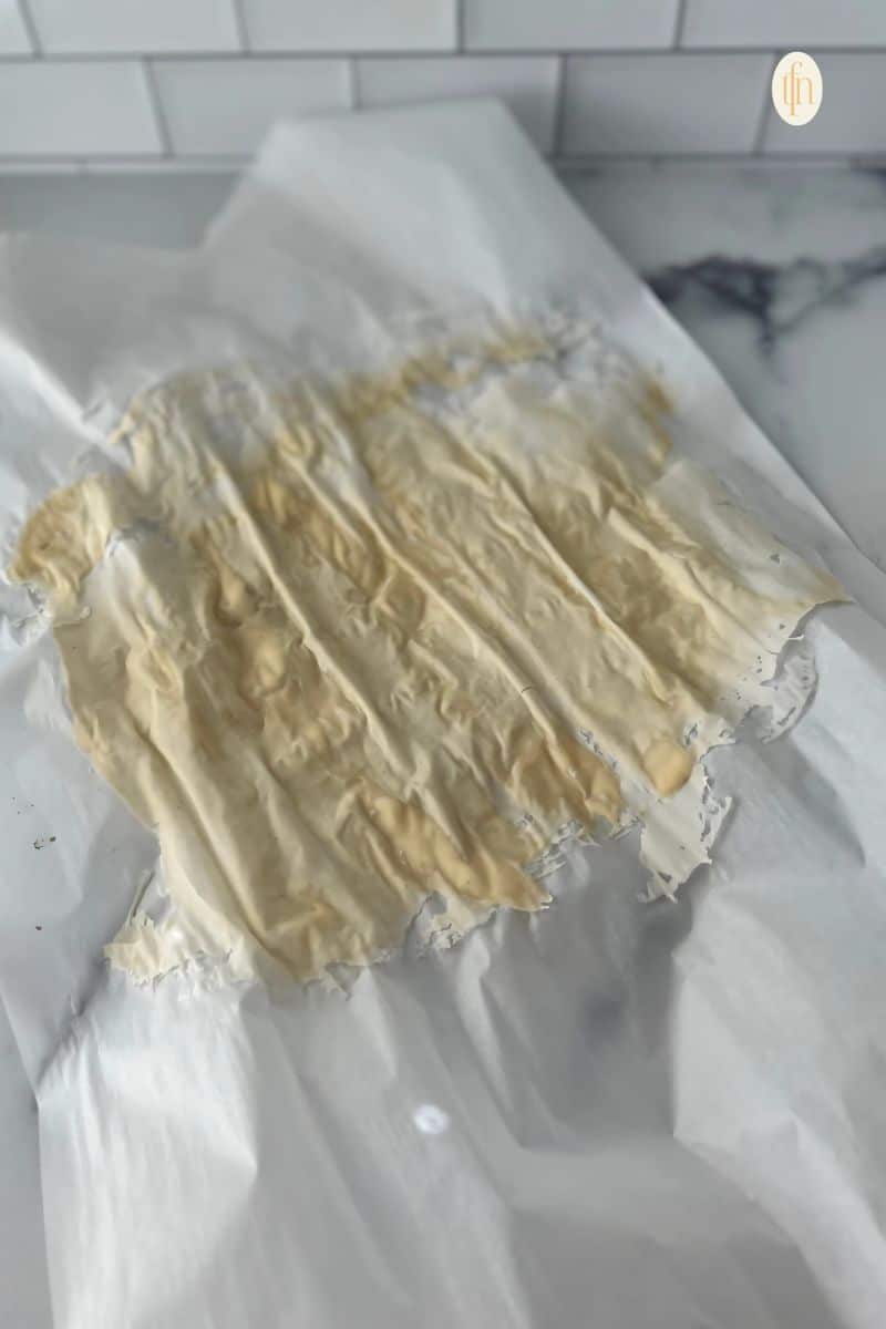 Dried sourdough starter on a parchment paper.