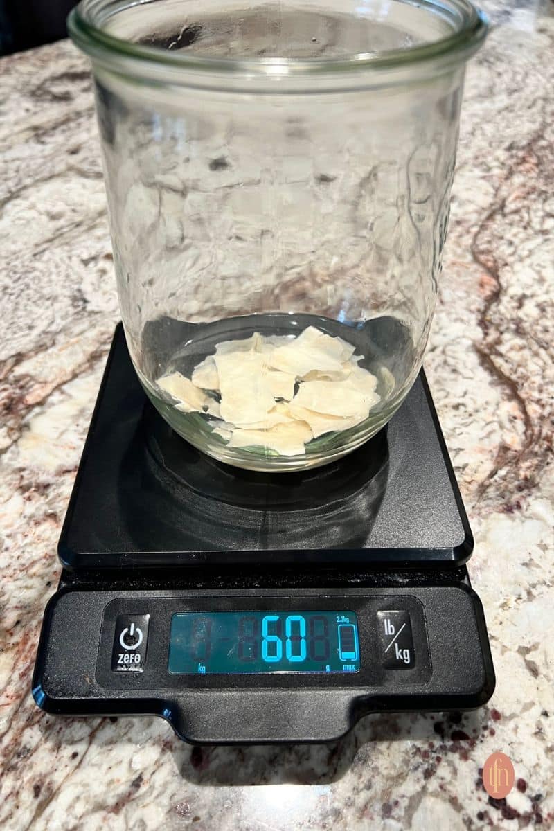 Dehydrated starter in a weck jar over a scale.