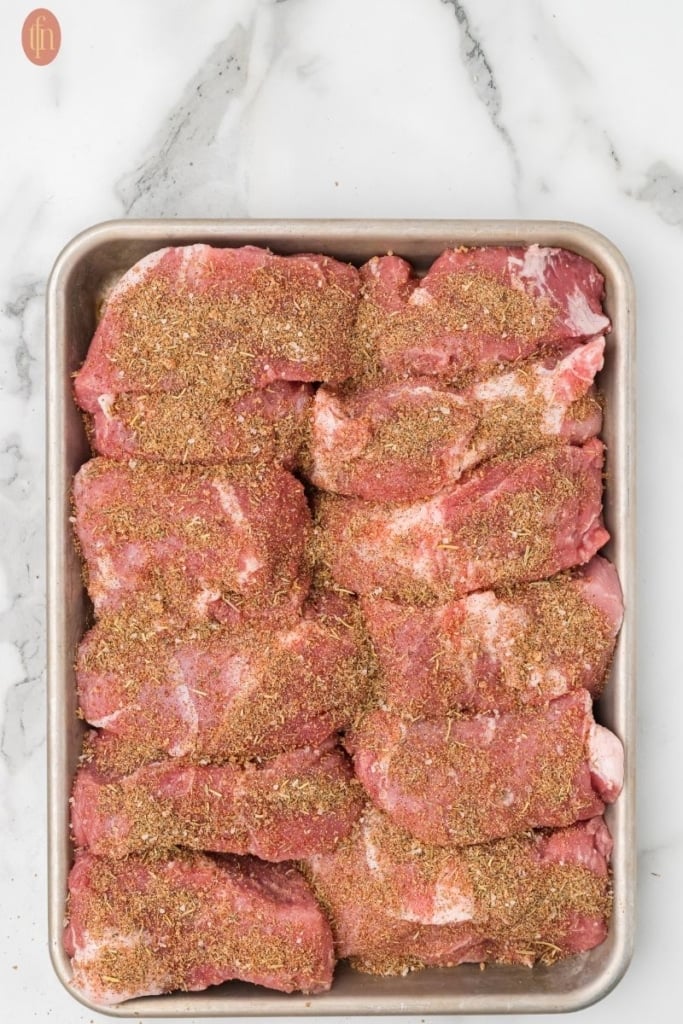 a prep image of Slow Cooker Country Style Ribs showing the meat covered with dry rub.
