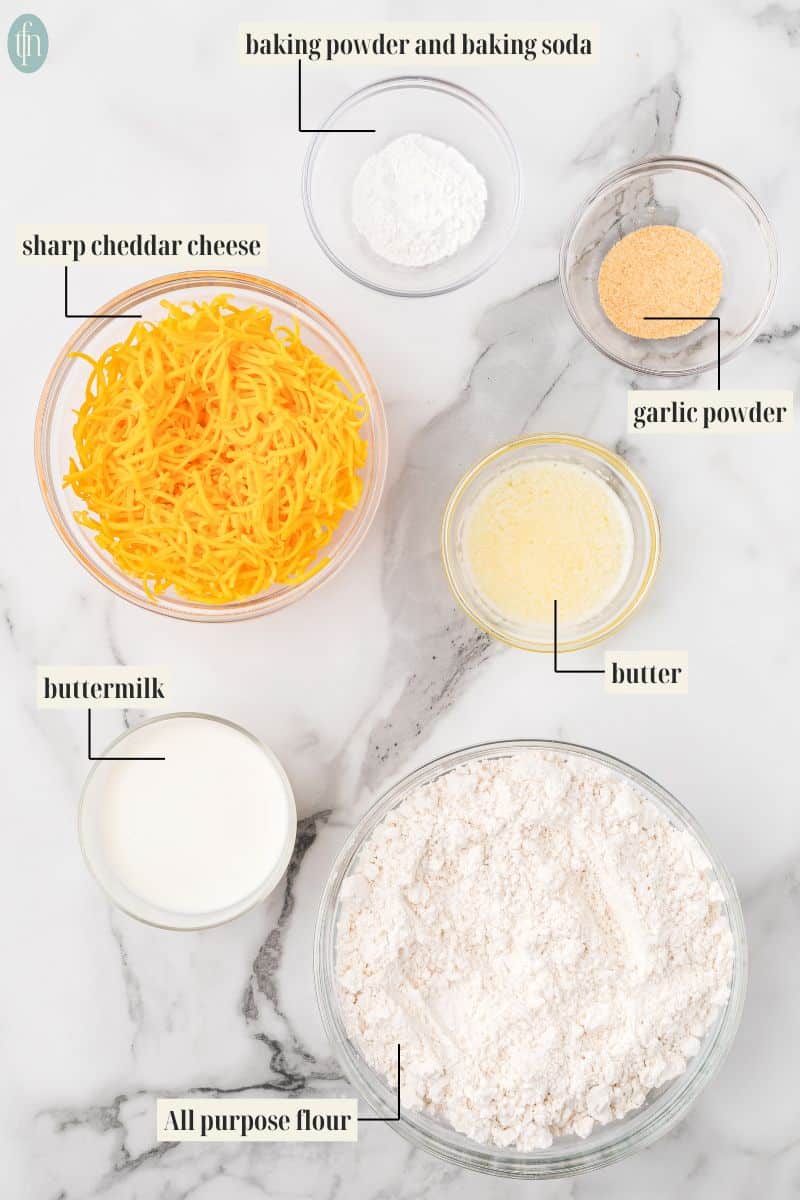 ingredient image for this recipe: baking powder and baking soda, sharp cheddar cheese, garlic powder, buttermilk, butter and all purpose flour.