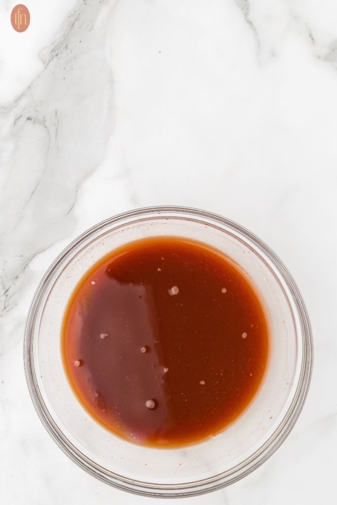 a bowl of the liquid ingredients for slow cooker country style ribs