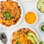 two plate of chicken slow cooker enchiladas.