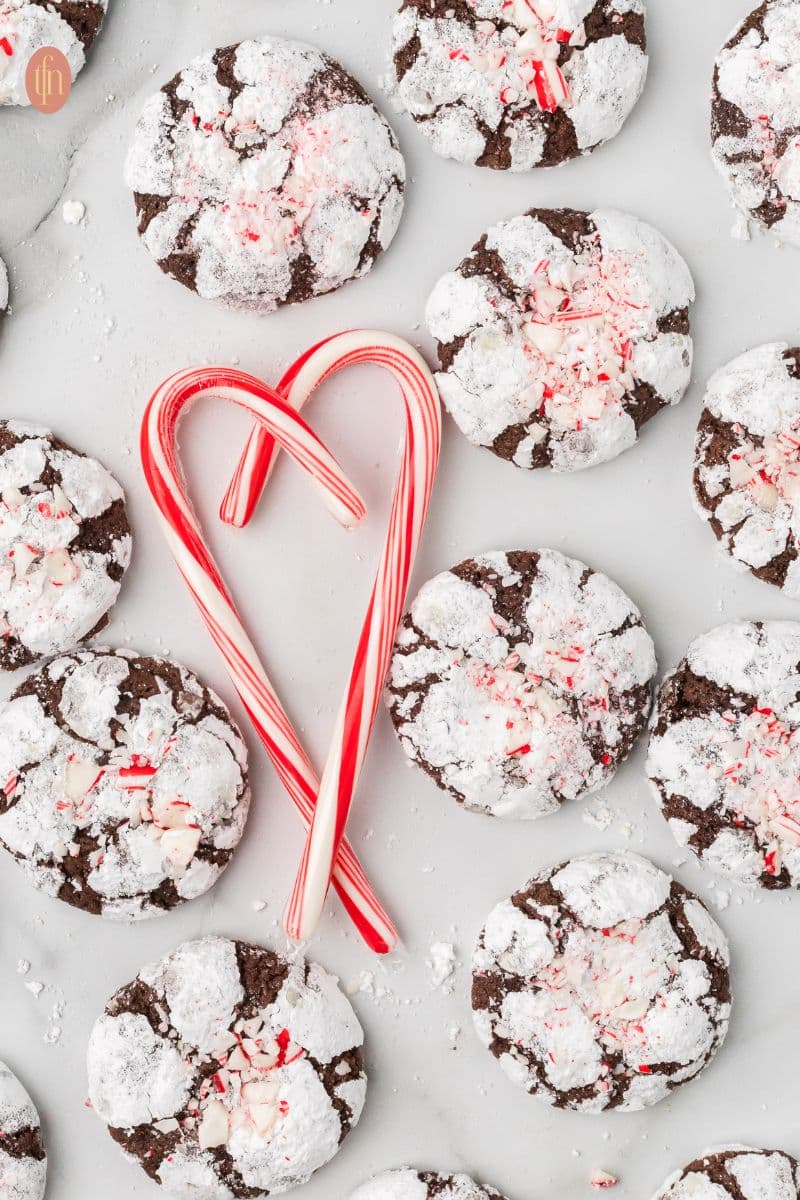 a graphic image of chocolate crinkle cookies with heart candy cane.