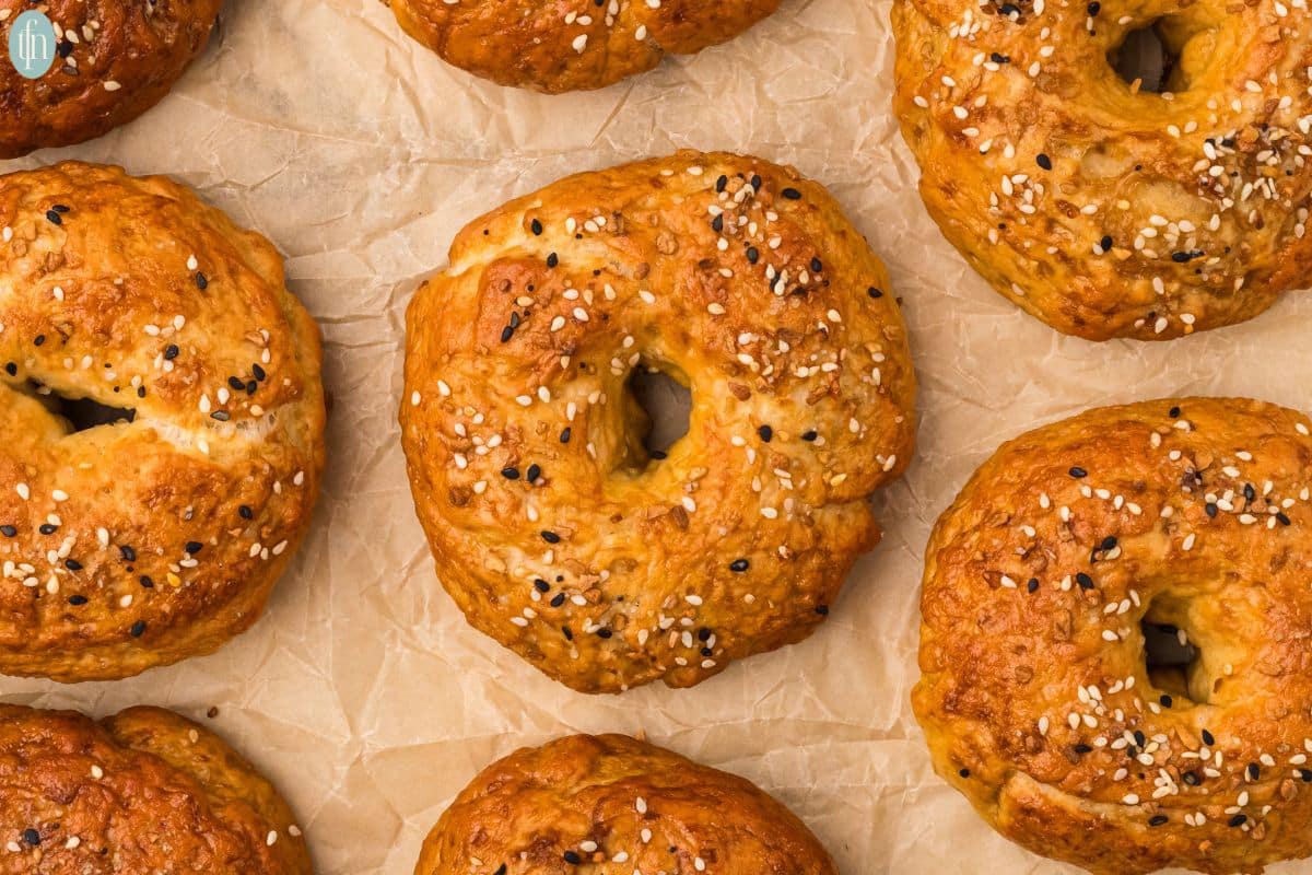 an image of a sourdough bagels on parchment paper.