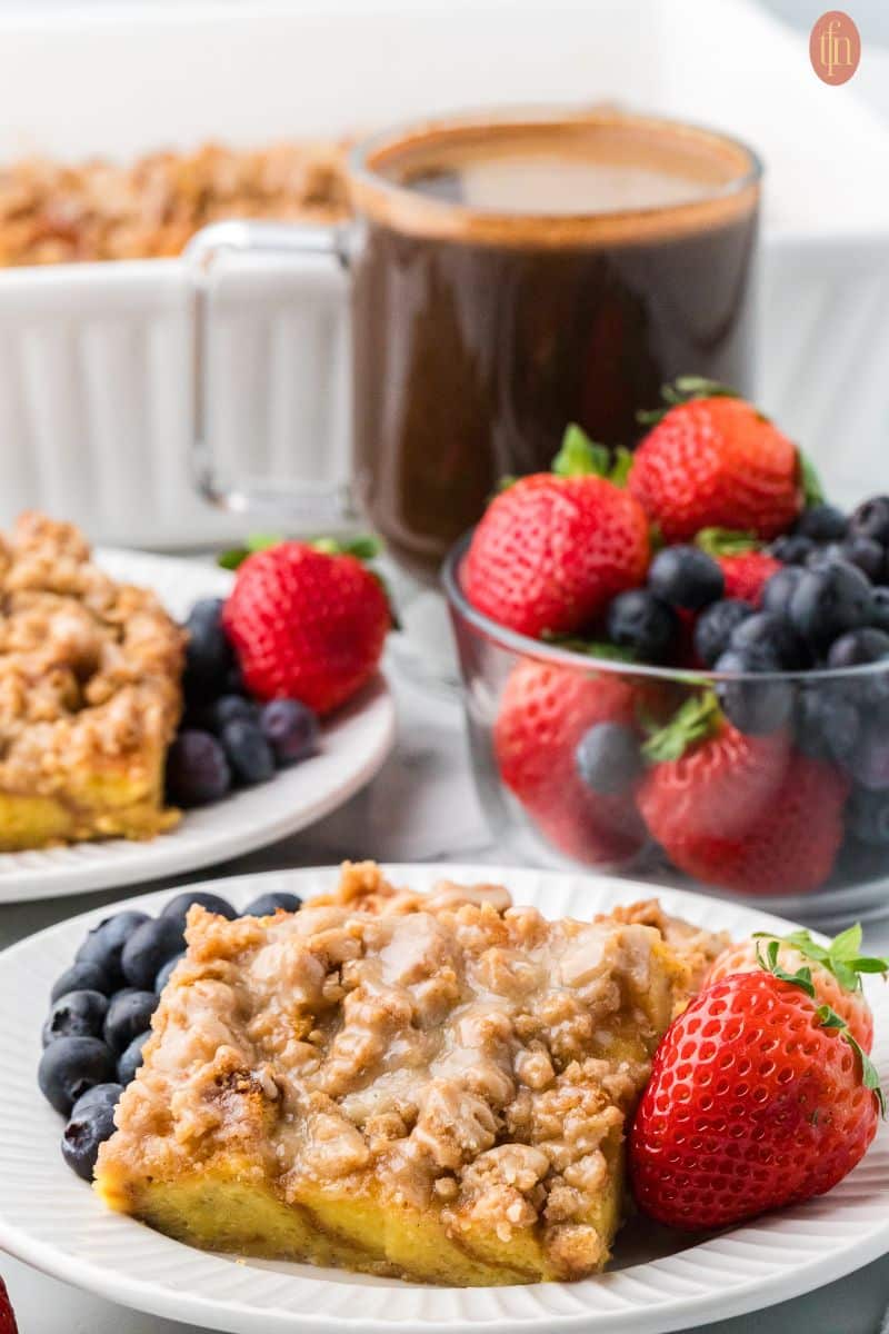 a plate of brioche french toast with blueberries and strawberries.