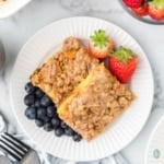 a plate of brioche french toast with blueberries and strawberries.