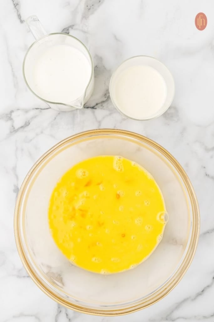 a bowl of egg, heavy cream and whole milk.