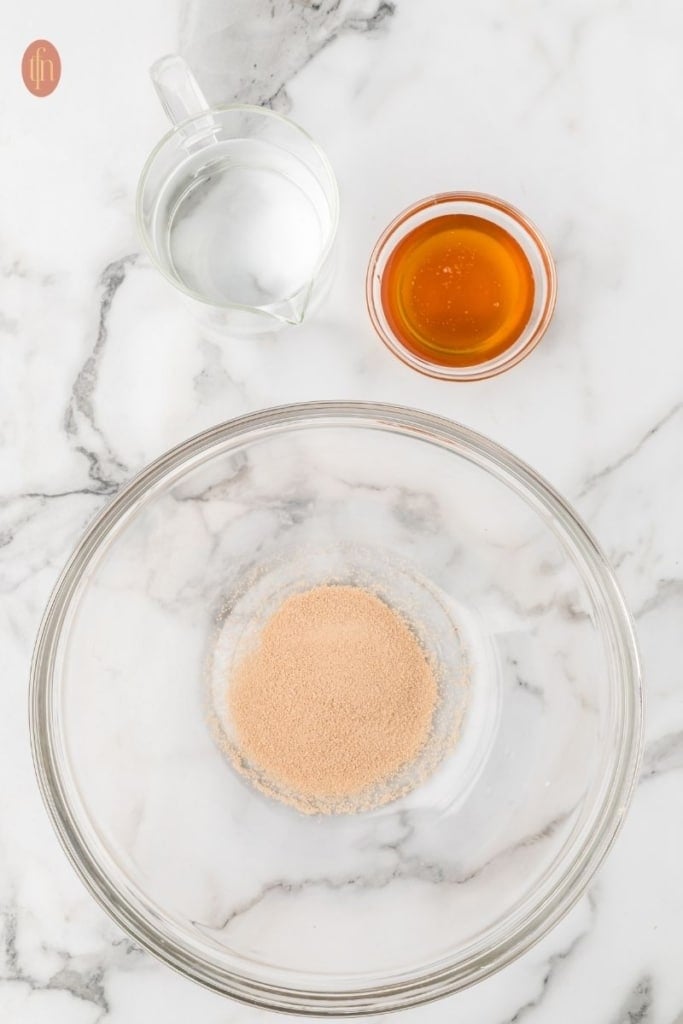 a bowl of honey, active dry yeast and warm water.