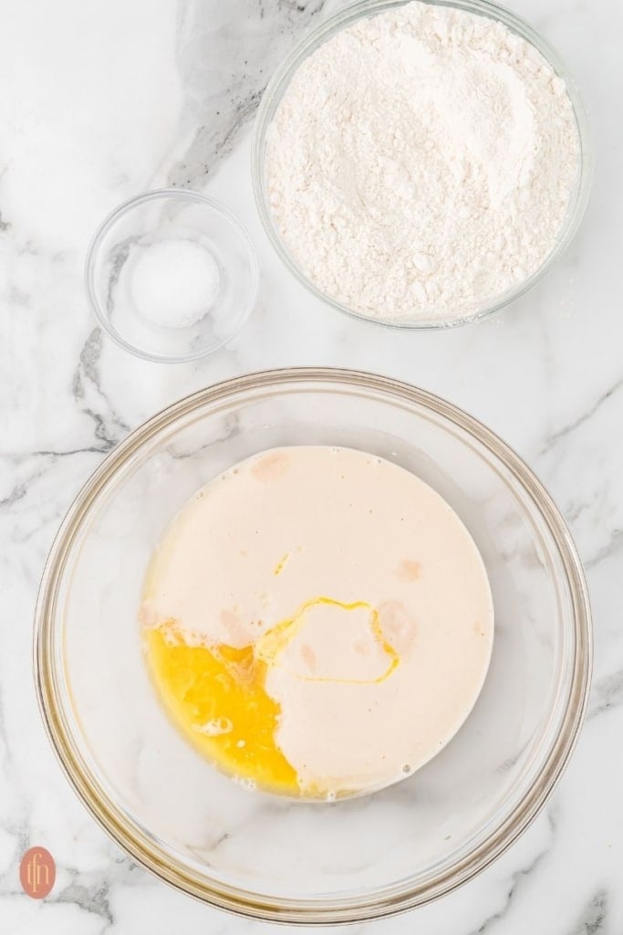 three glass bowls of ingredients for dinner roll.