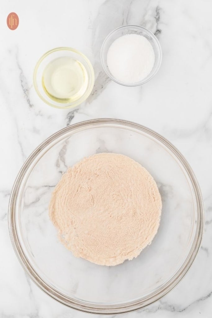 a bowl of active dry yeast, cooking oil and sugar.