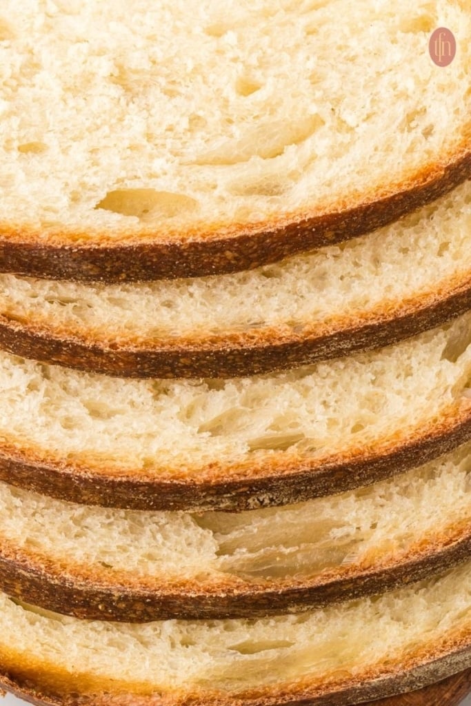 a close up shot of sliced soft sourdough sandwich bread.