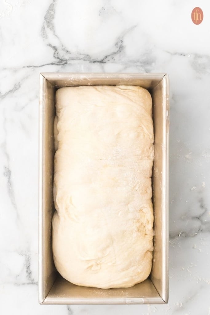 an image of a dough in a loaf pan.