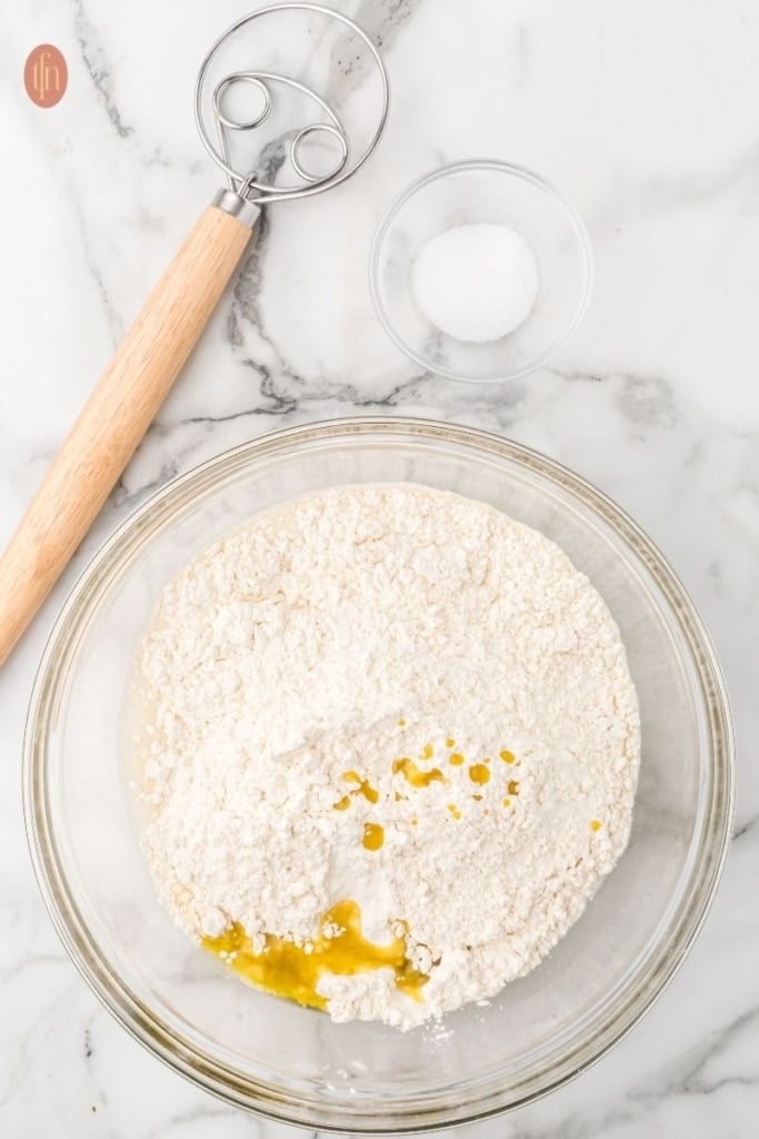 sourdough sandwich bread in glass mixing bowls.